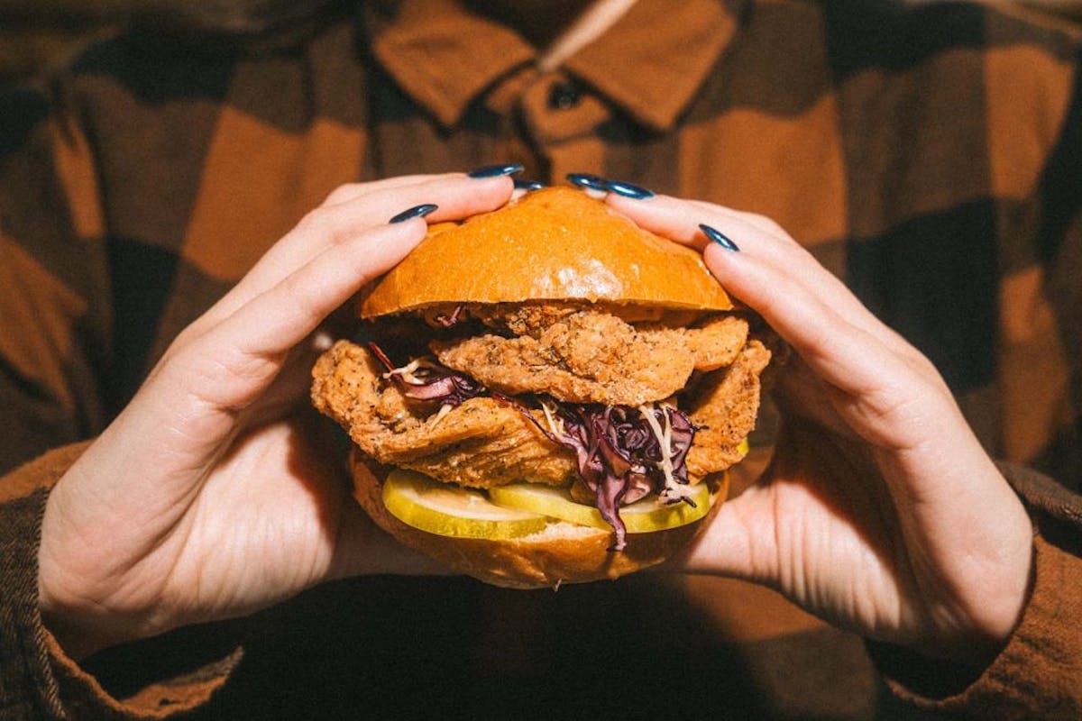 a close up of a hand holding a sandwich