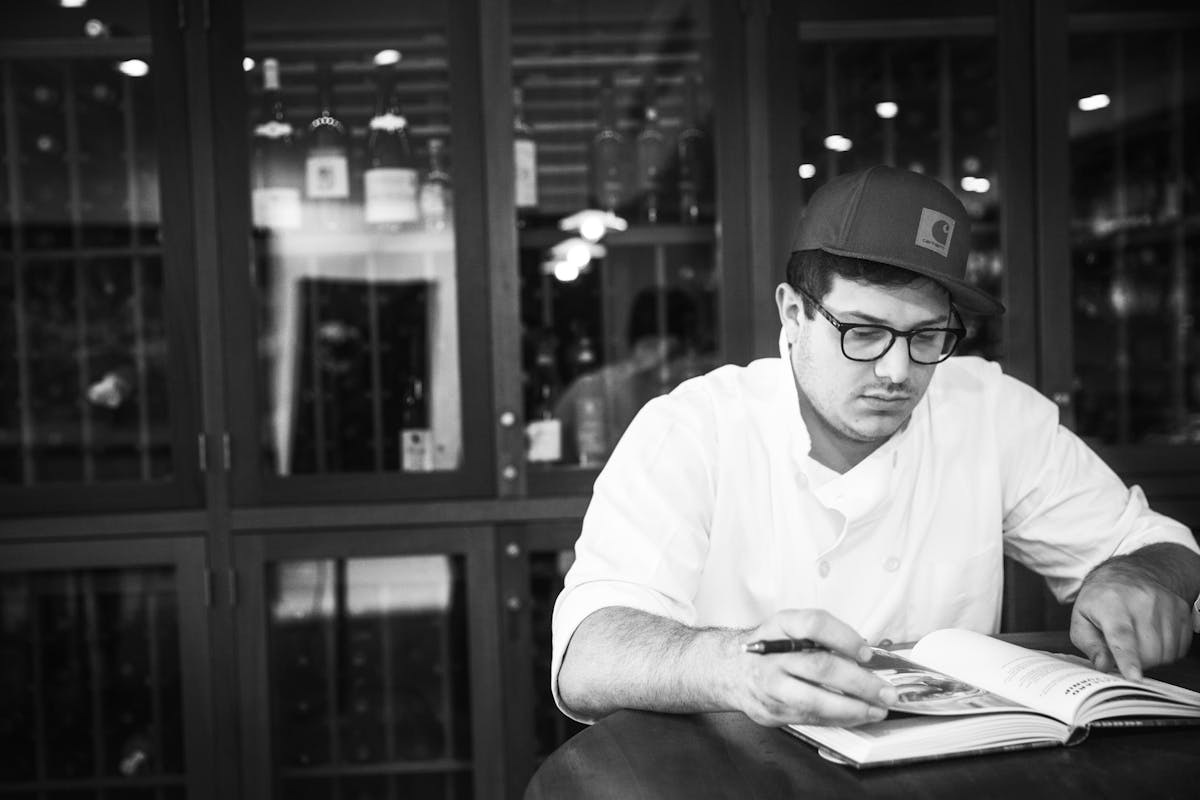 a man sitting at a table using a laptop