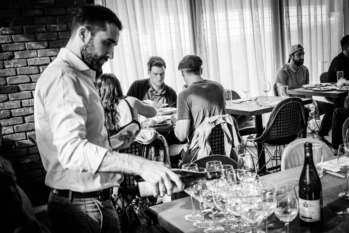 a group of people sitting at a table with wine glasses