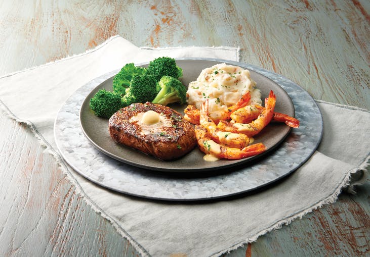 a plate of food sitting on top of a wooden table