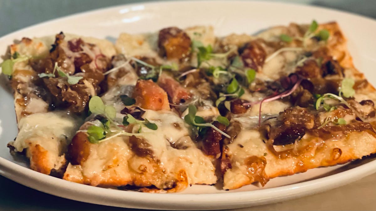a pizza sitting on top of a plate of food