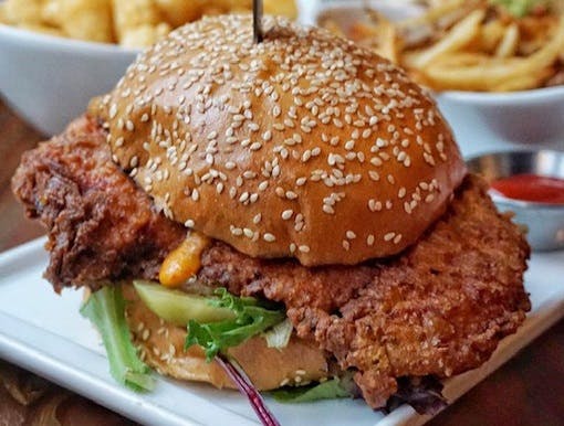 a close up of a sandwich and fries on a plate