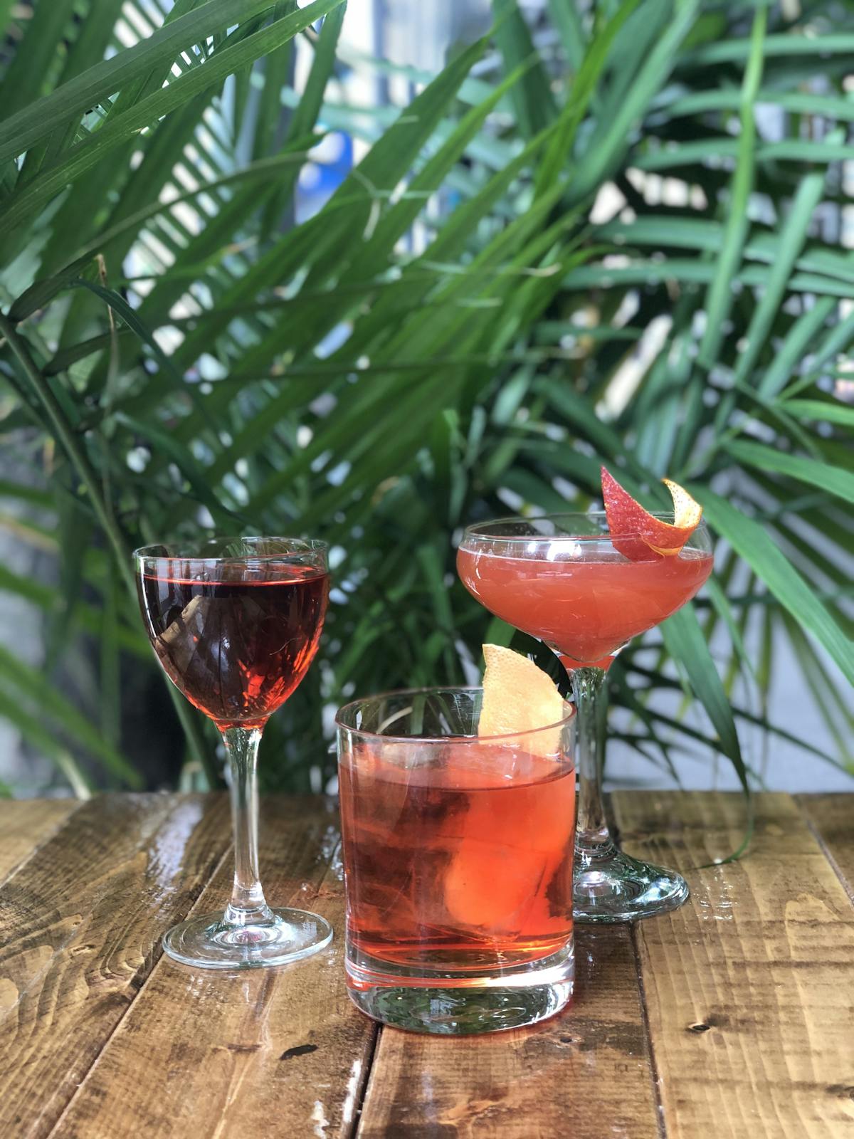 a glass of wine sitting on top of a wooden table