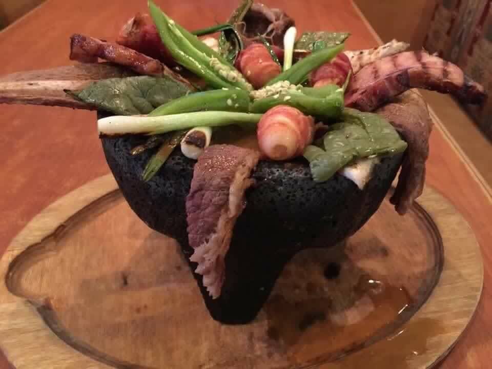 a plate of food on a wooden table