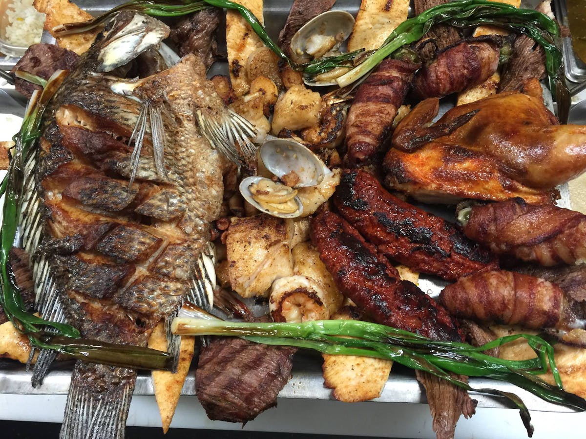 a tray of food with meat and vegetables