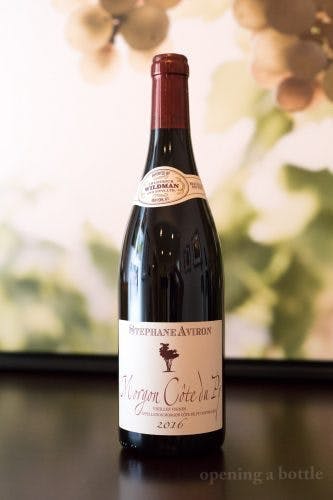 a close up of a bottle and a glass of wine