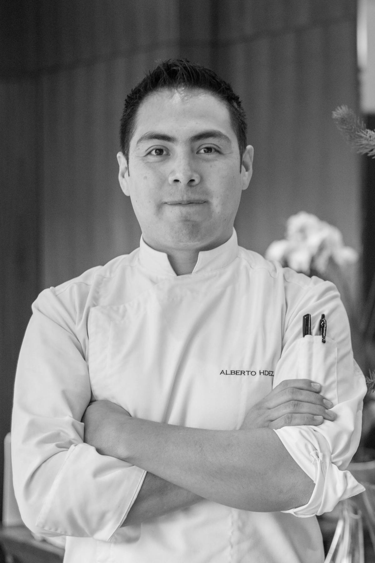 a man with arms crossed posing for a photo