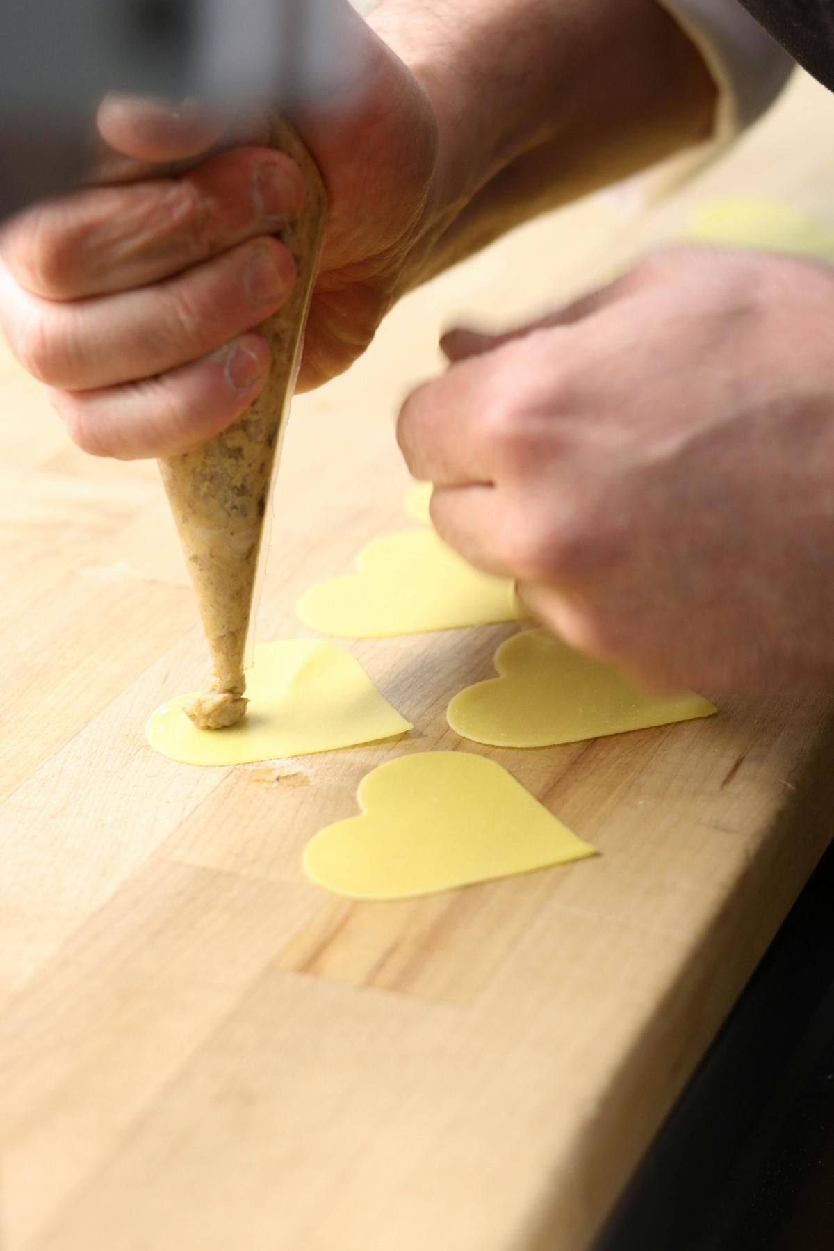 a person sitting on a wooden cutting board