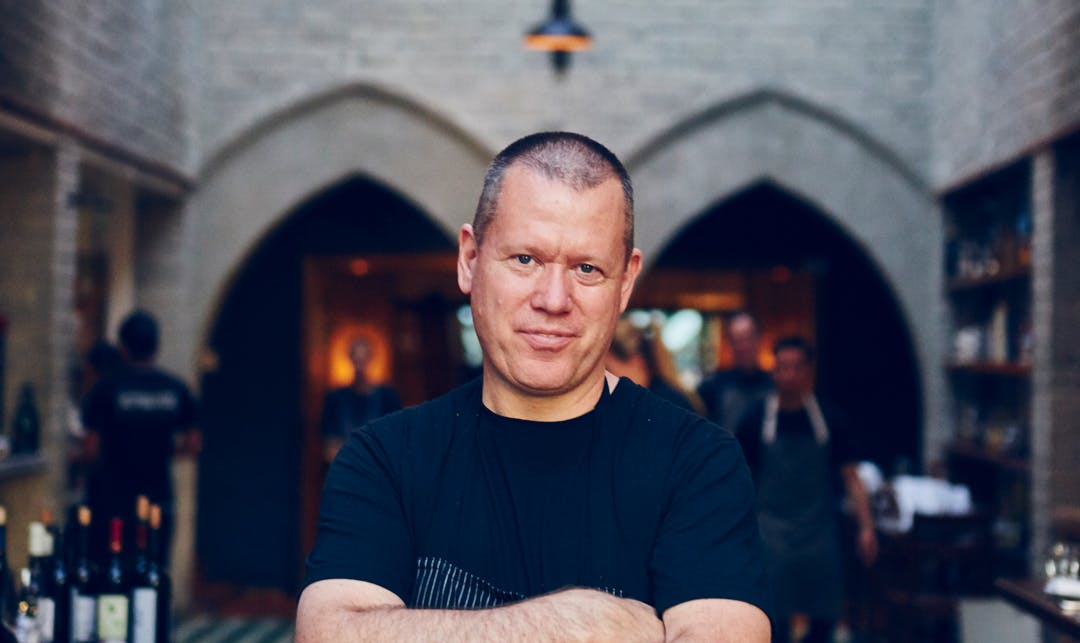 a man with his arms crossed posing for the camera