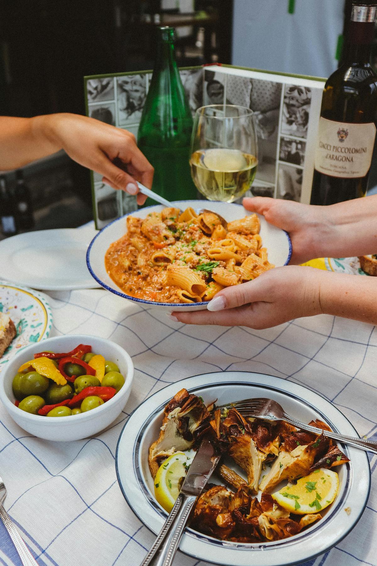 a woman sitting at a table with a plate of food