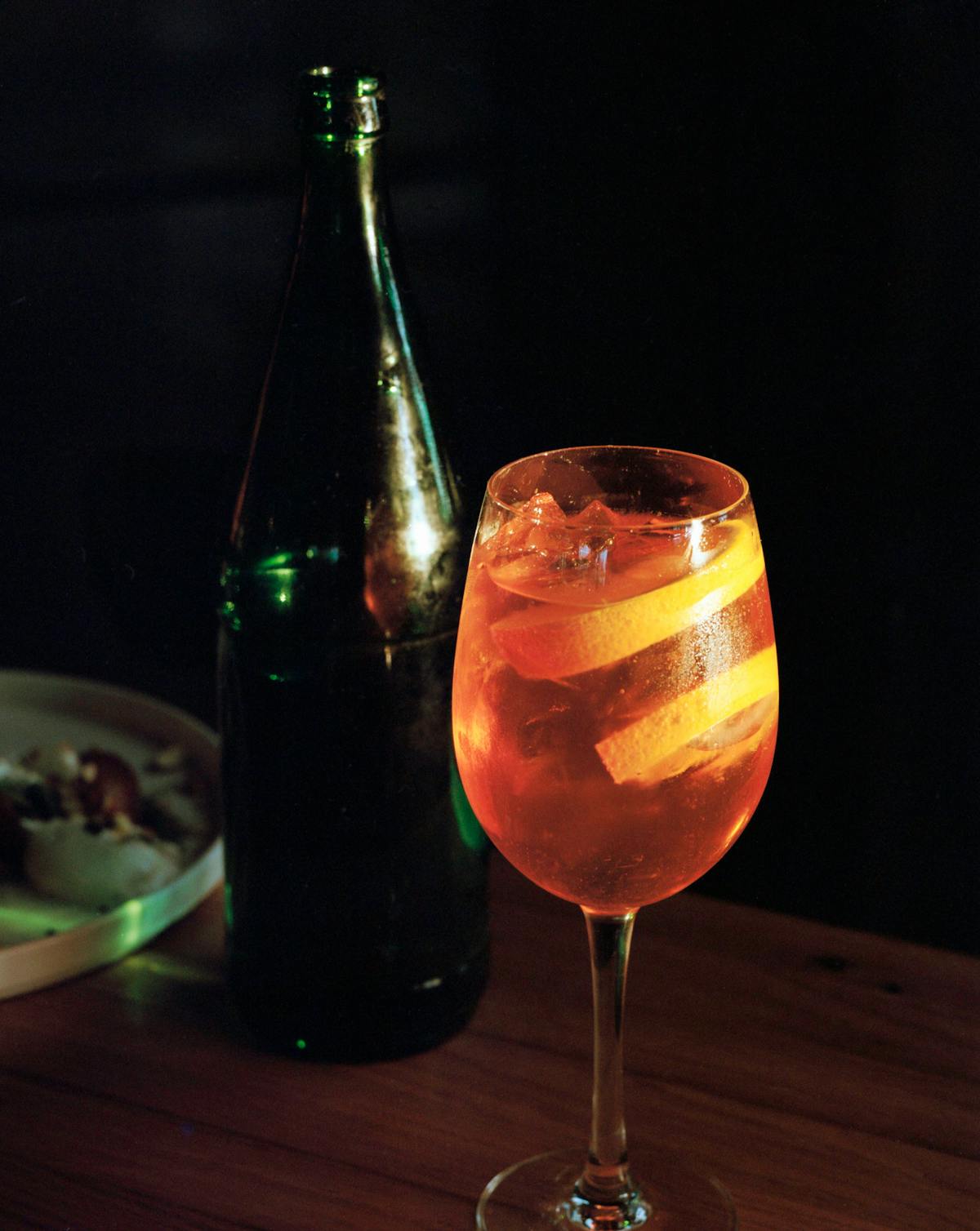 a bottle of wine and a glass of beer on a table