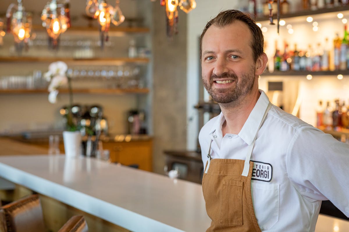 a man standing in front of a table