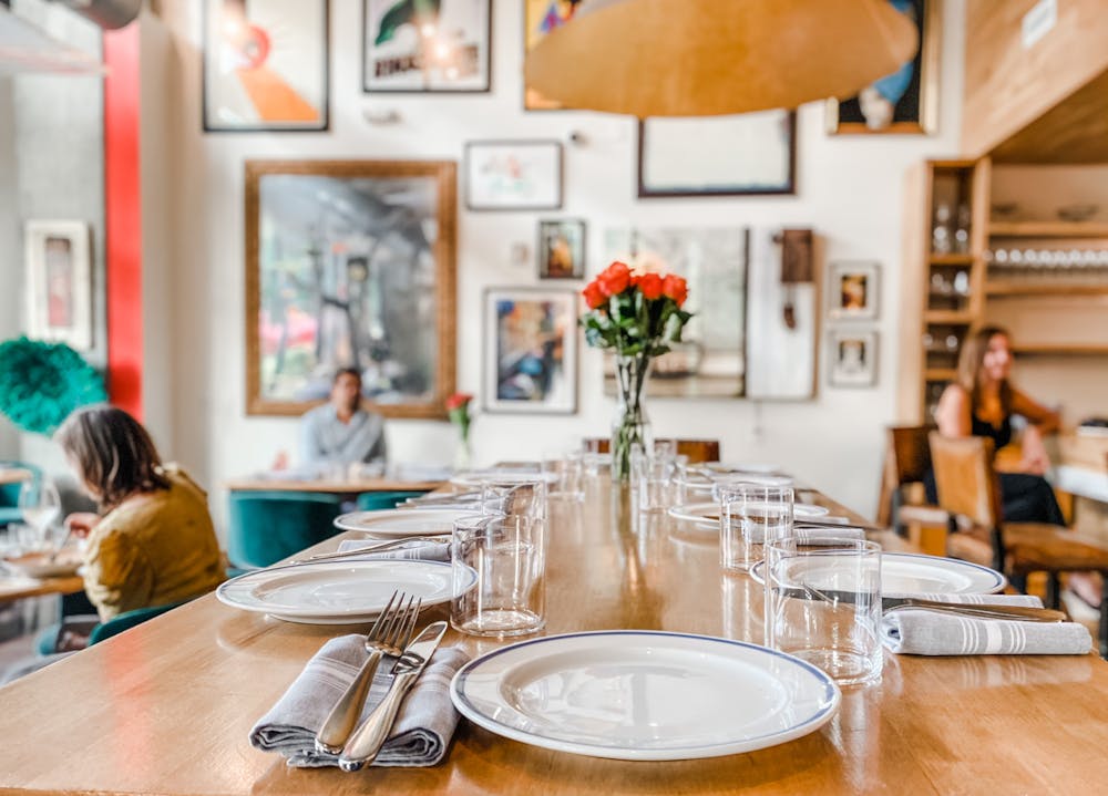 a person sitting at a table with wine glasses