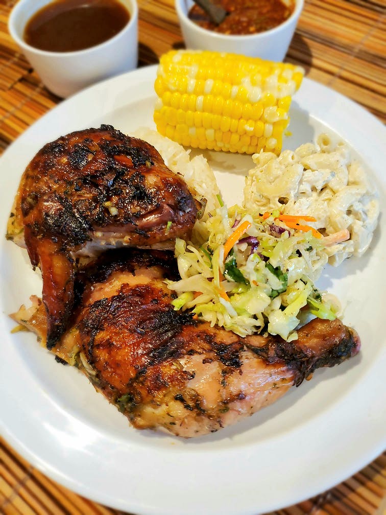 a white plate topped with meat and vegetables