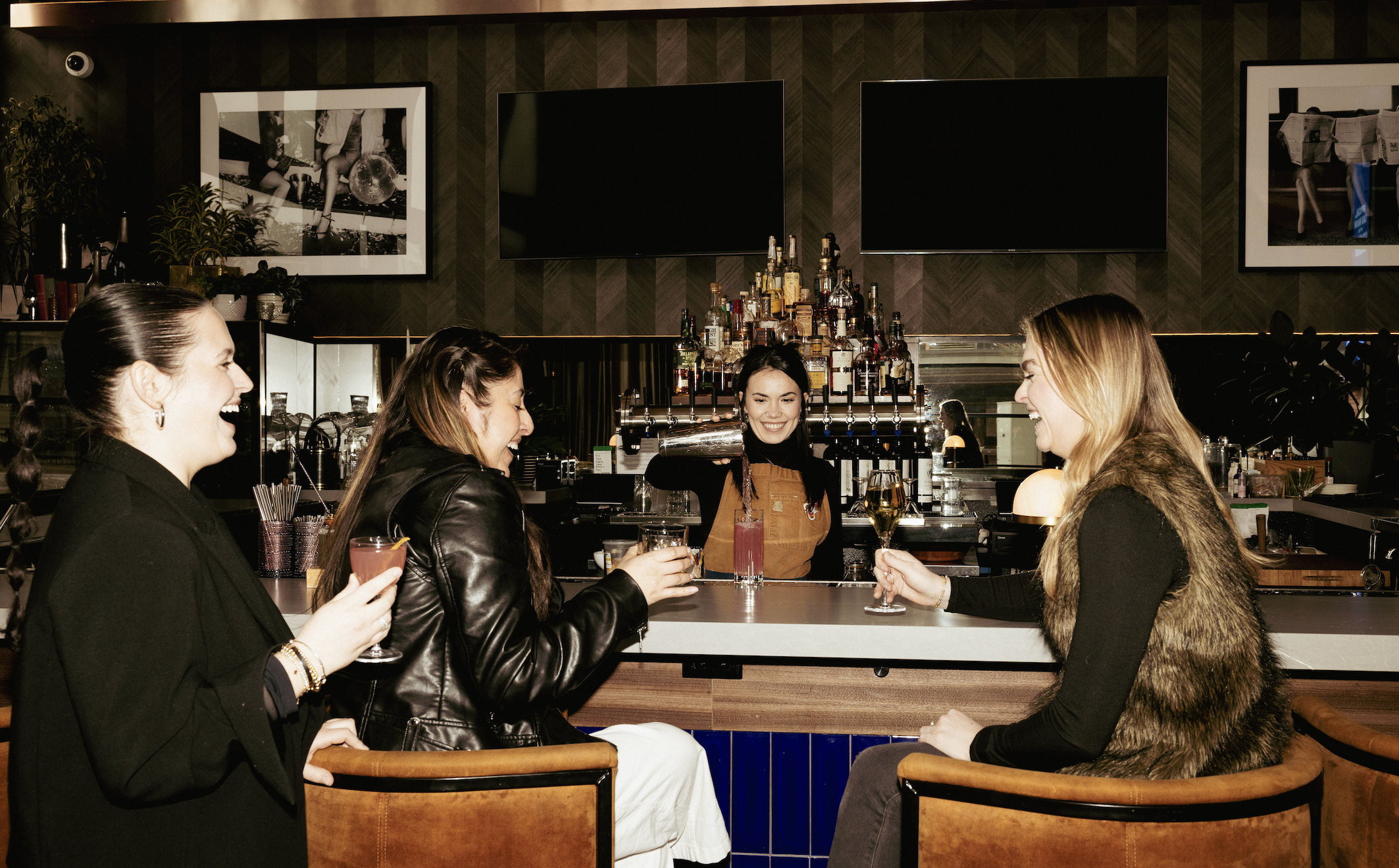 a group of people sitting at the bar