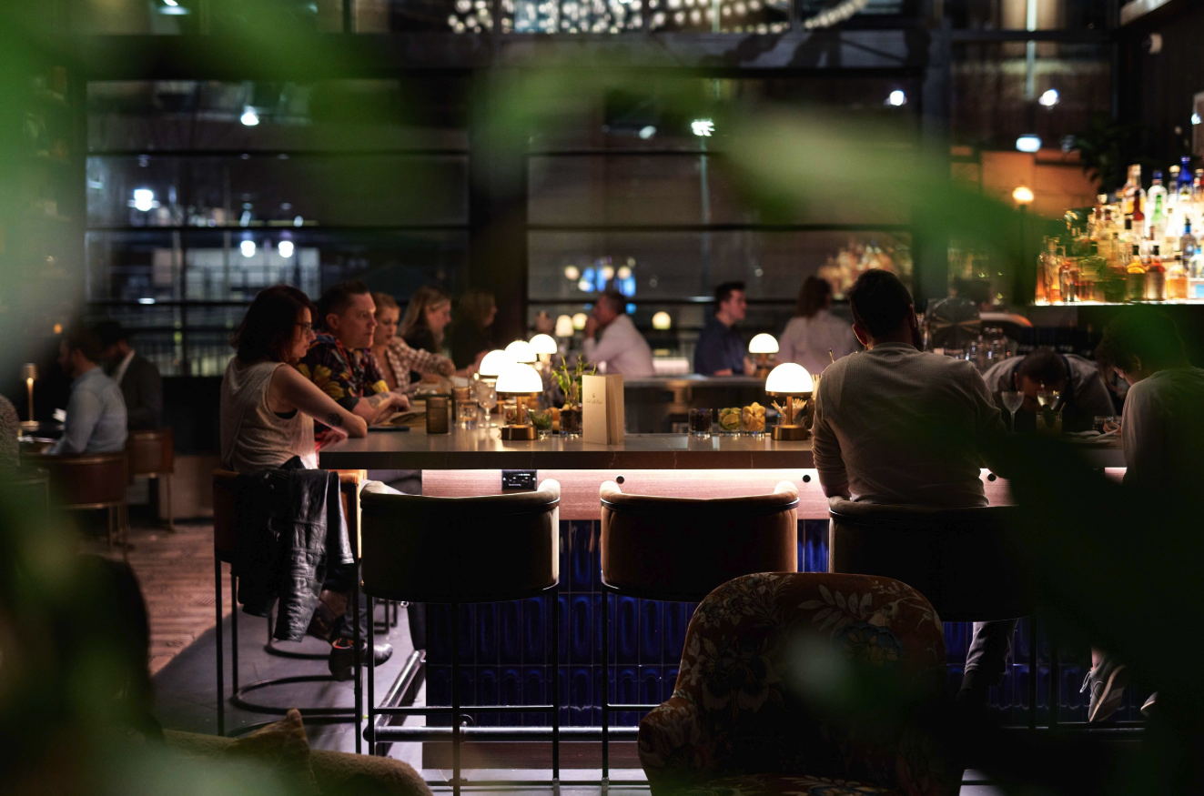 a group of people sitting at a table in a restaurant