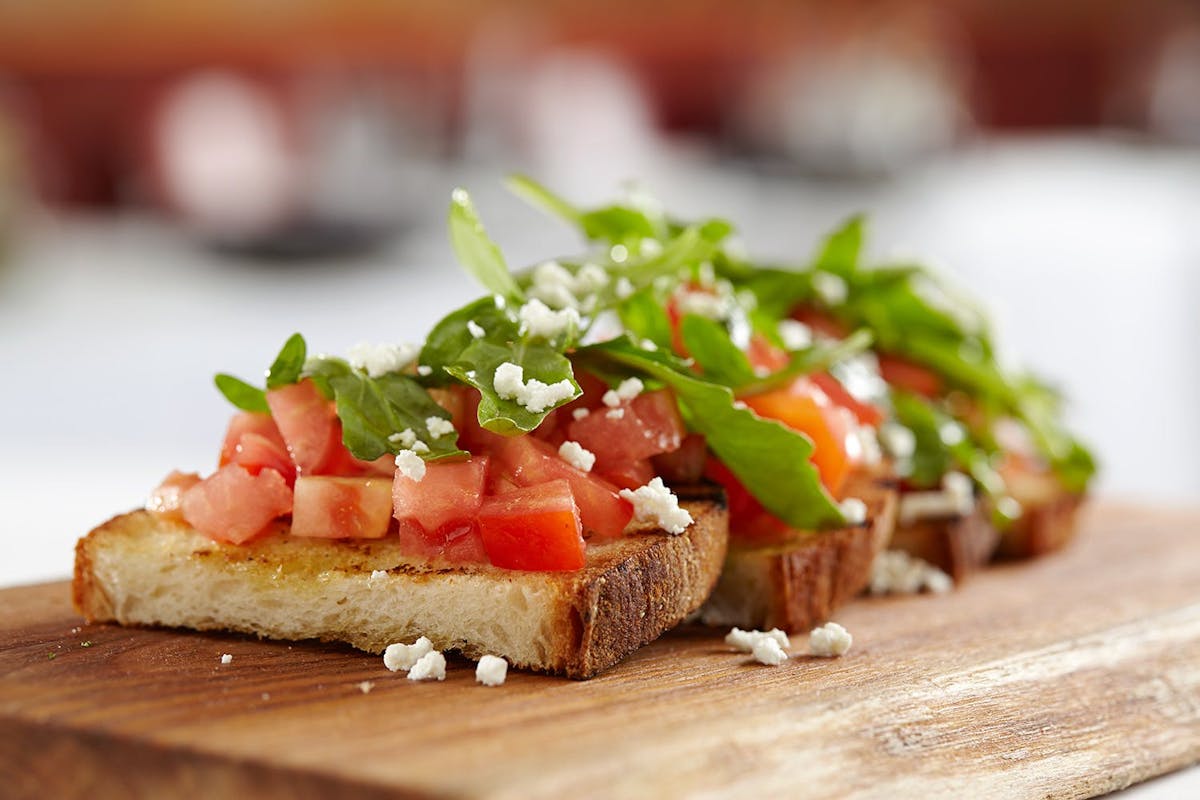 a close up of food on a wooden cutting board