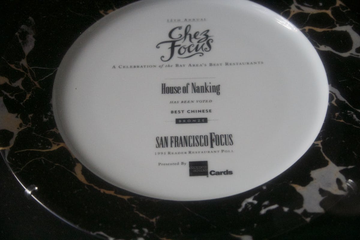 a black sign with white text on a white plate