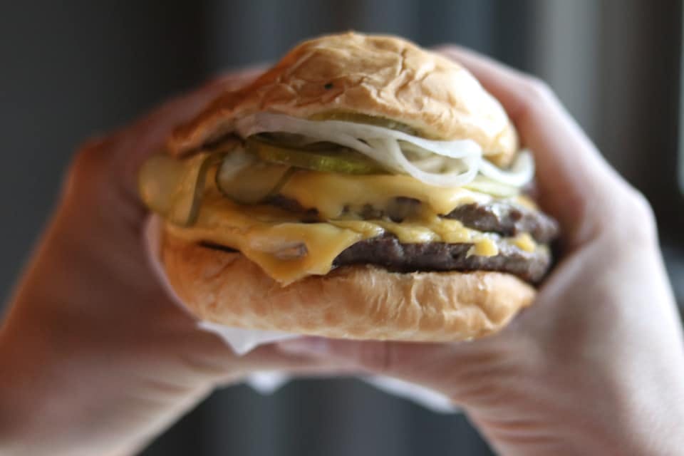 a close up of a hand holding a sandwich