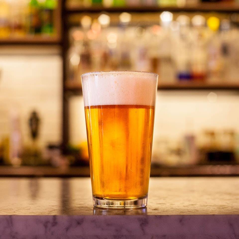 a close up of a glass of beer on a table