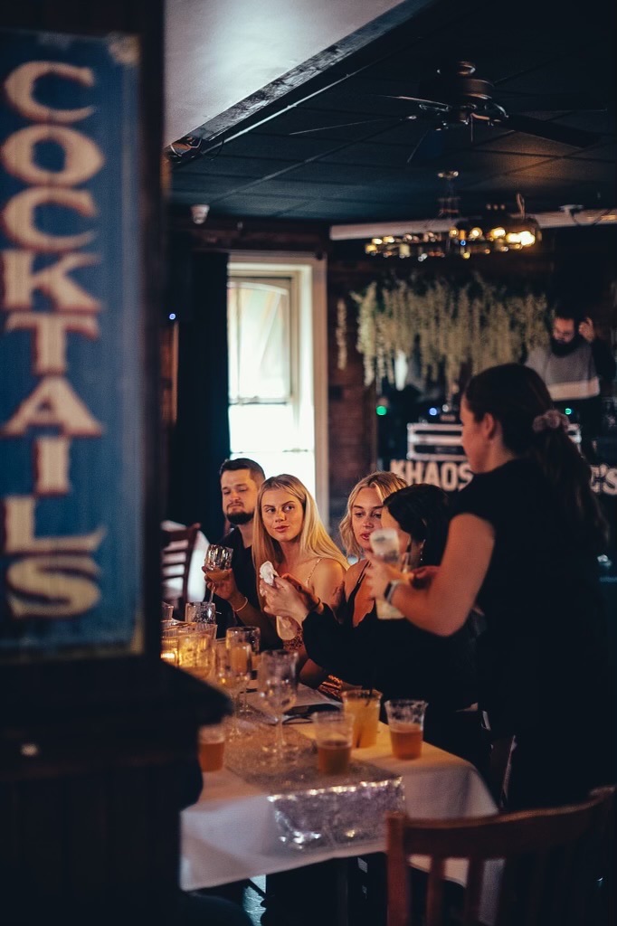 a group of people sitting at a table in a restaurant