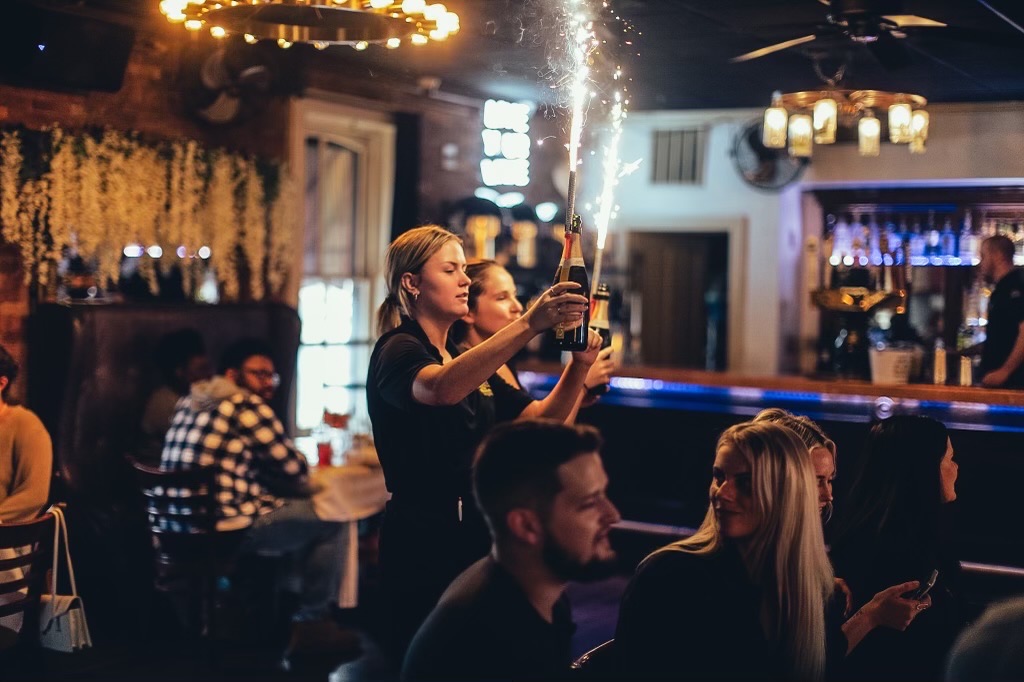 a group of people sitting at a table in front of a crowd