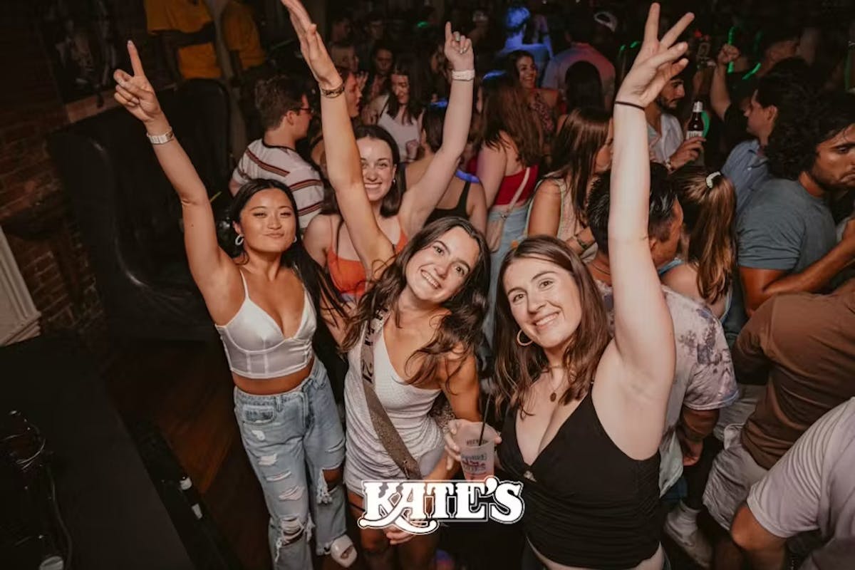 a group of people standing in front of a crowd posing for the camera
