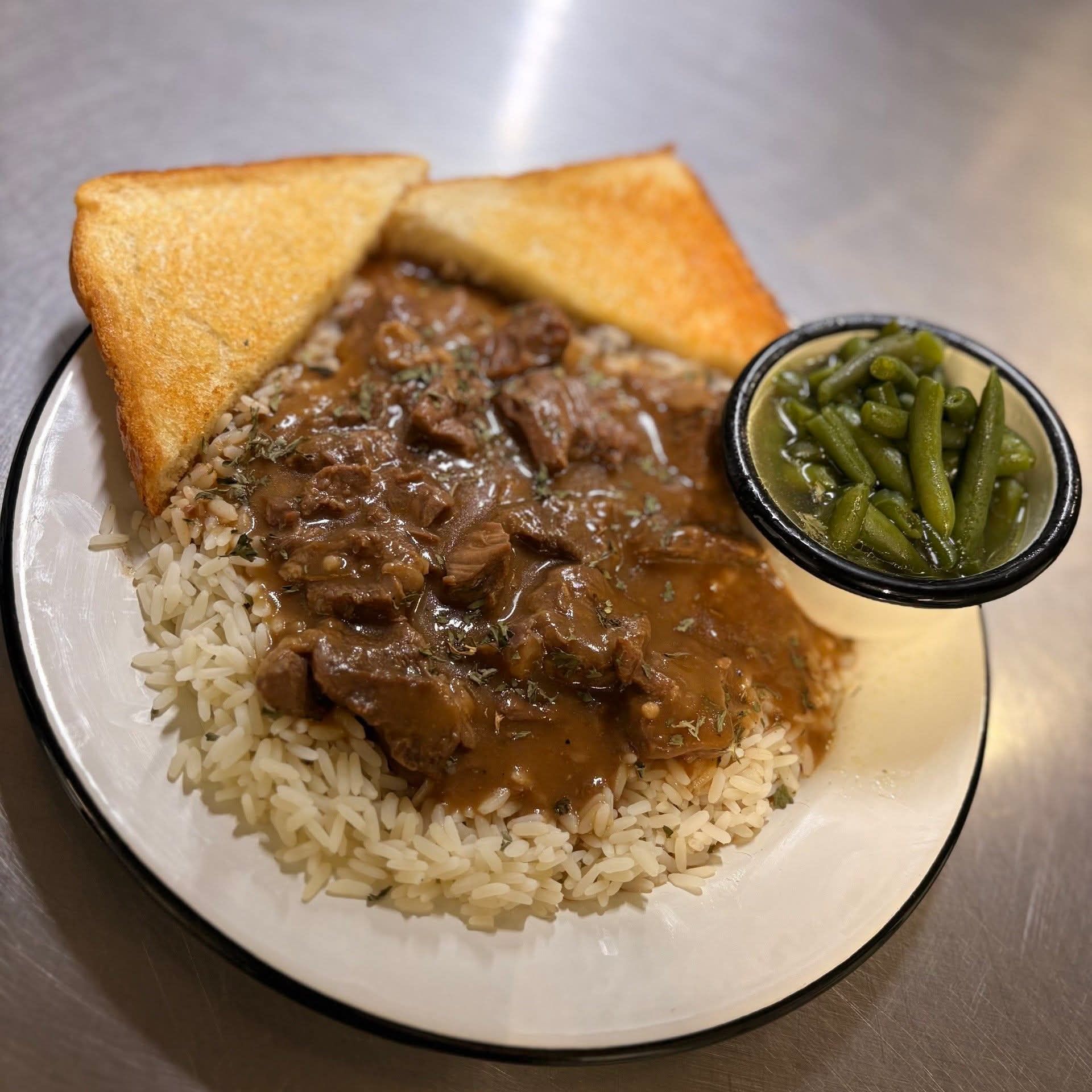 a plate of food with toasted bread and meat
