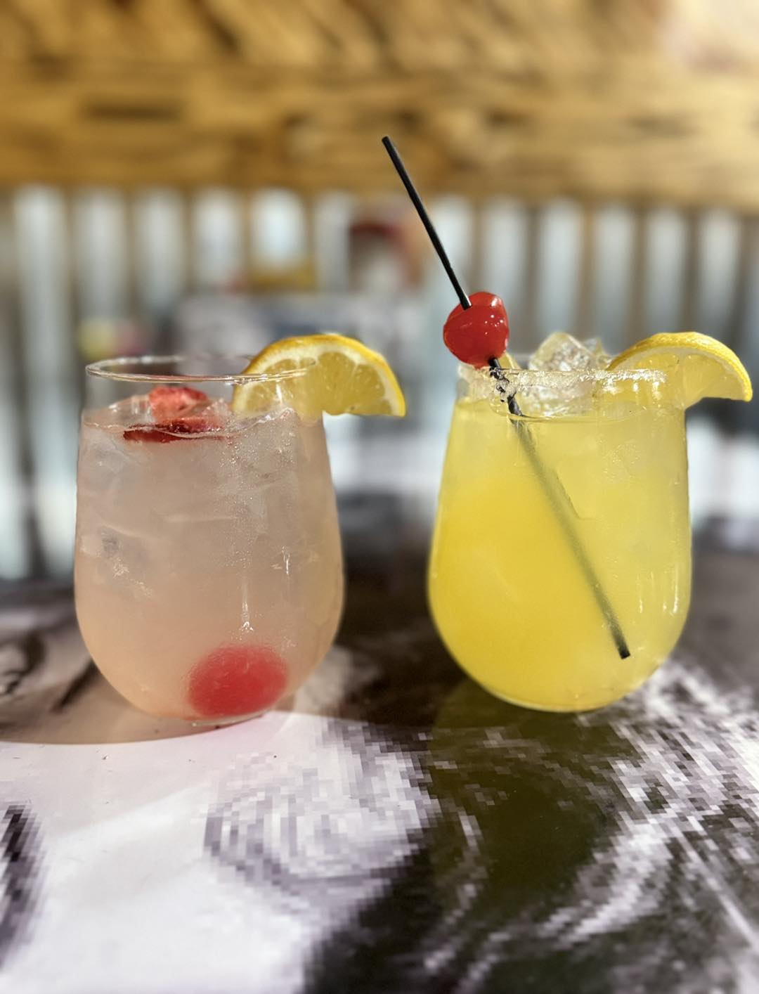 two glasses with drinks on a table