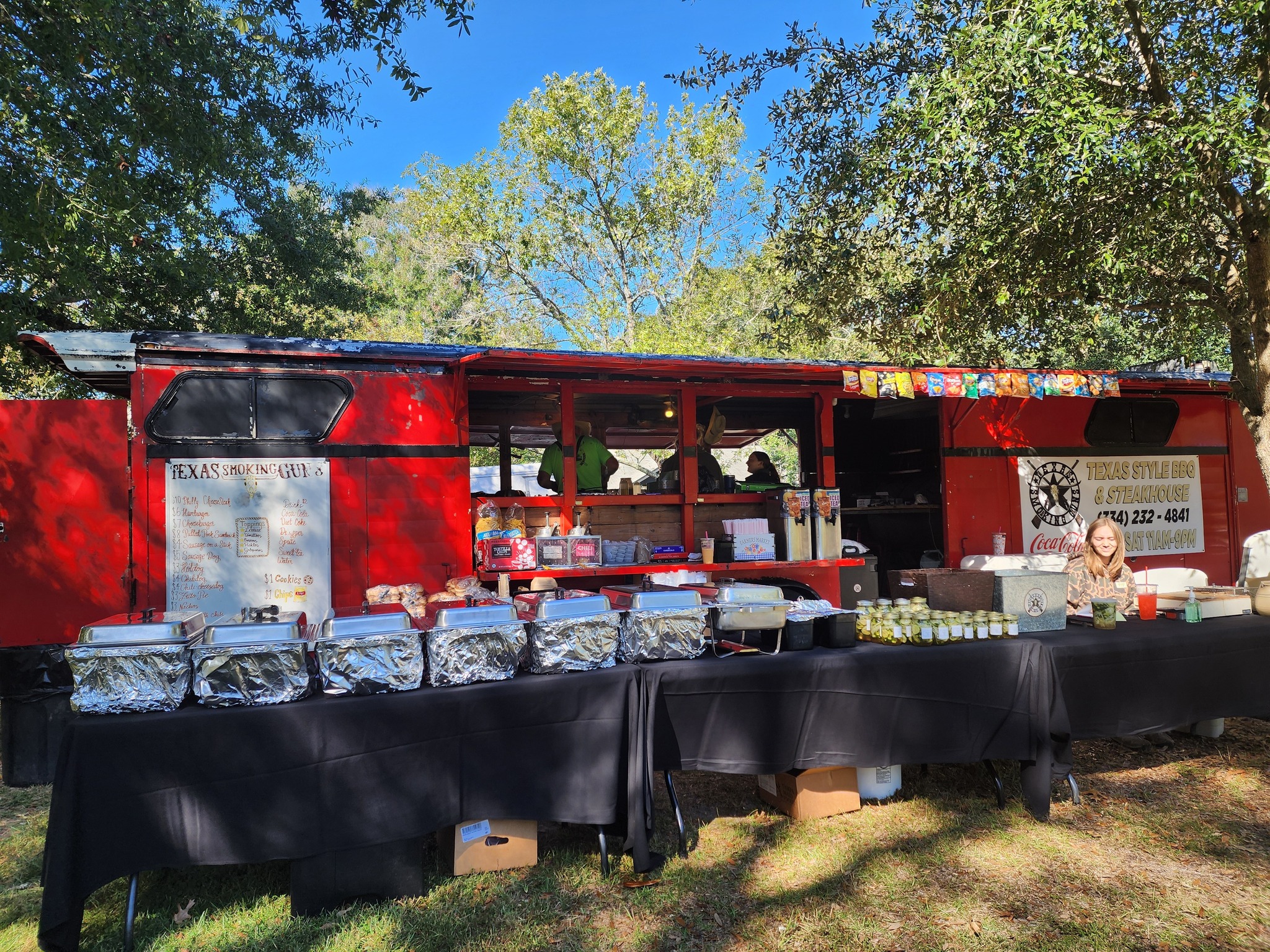 a food truck with a woman standing behind it