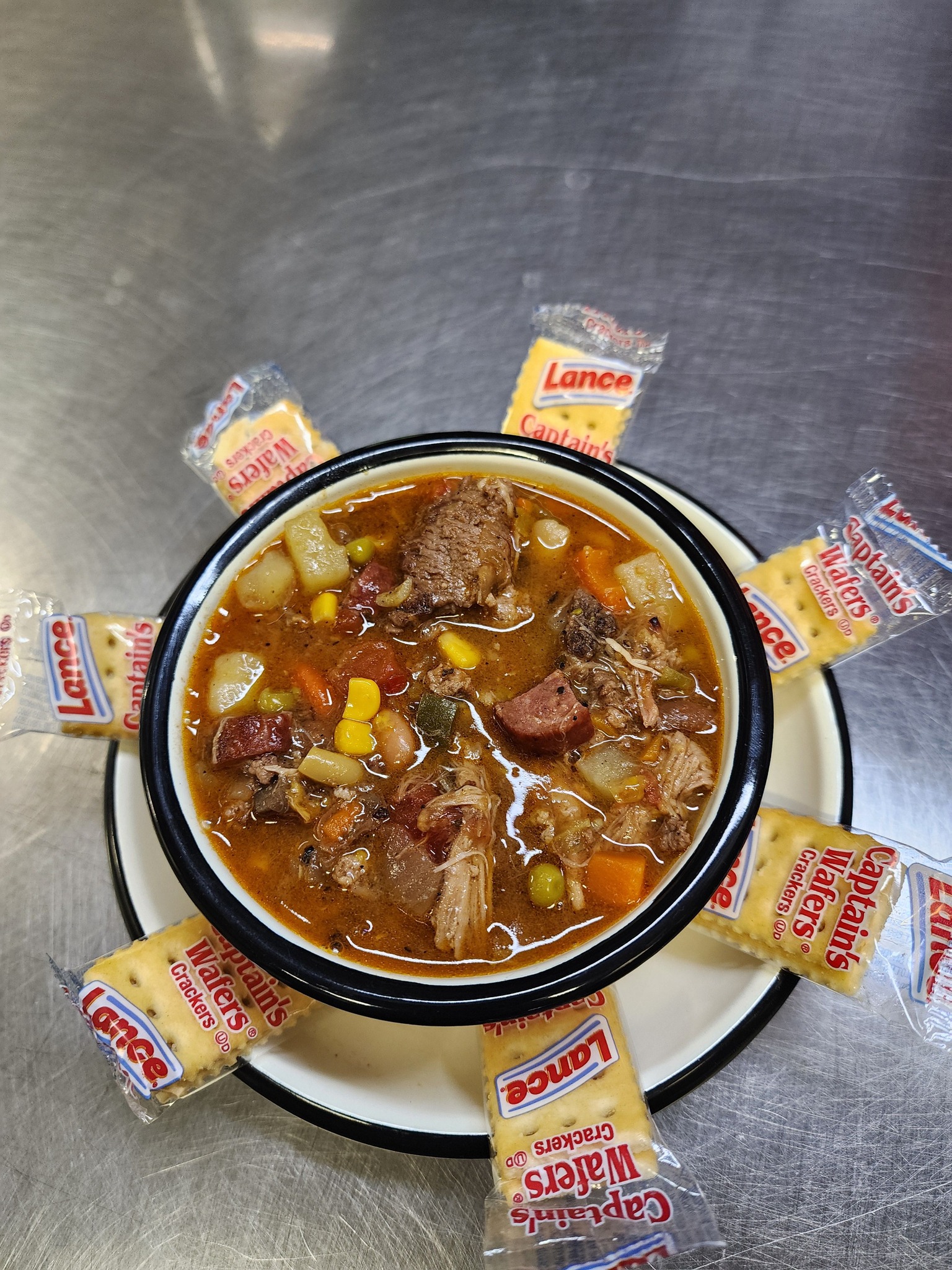 a bowl of soup with crackers on top