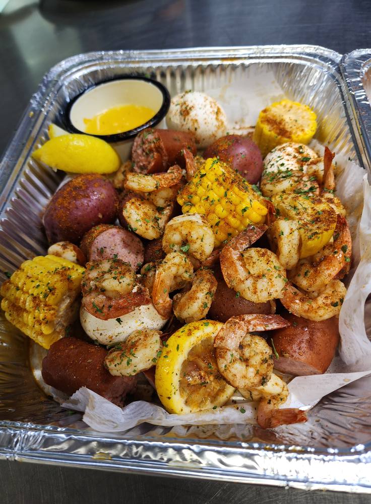 a tray of shrimp and corn