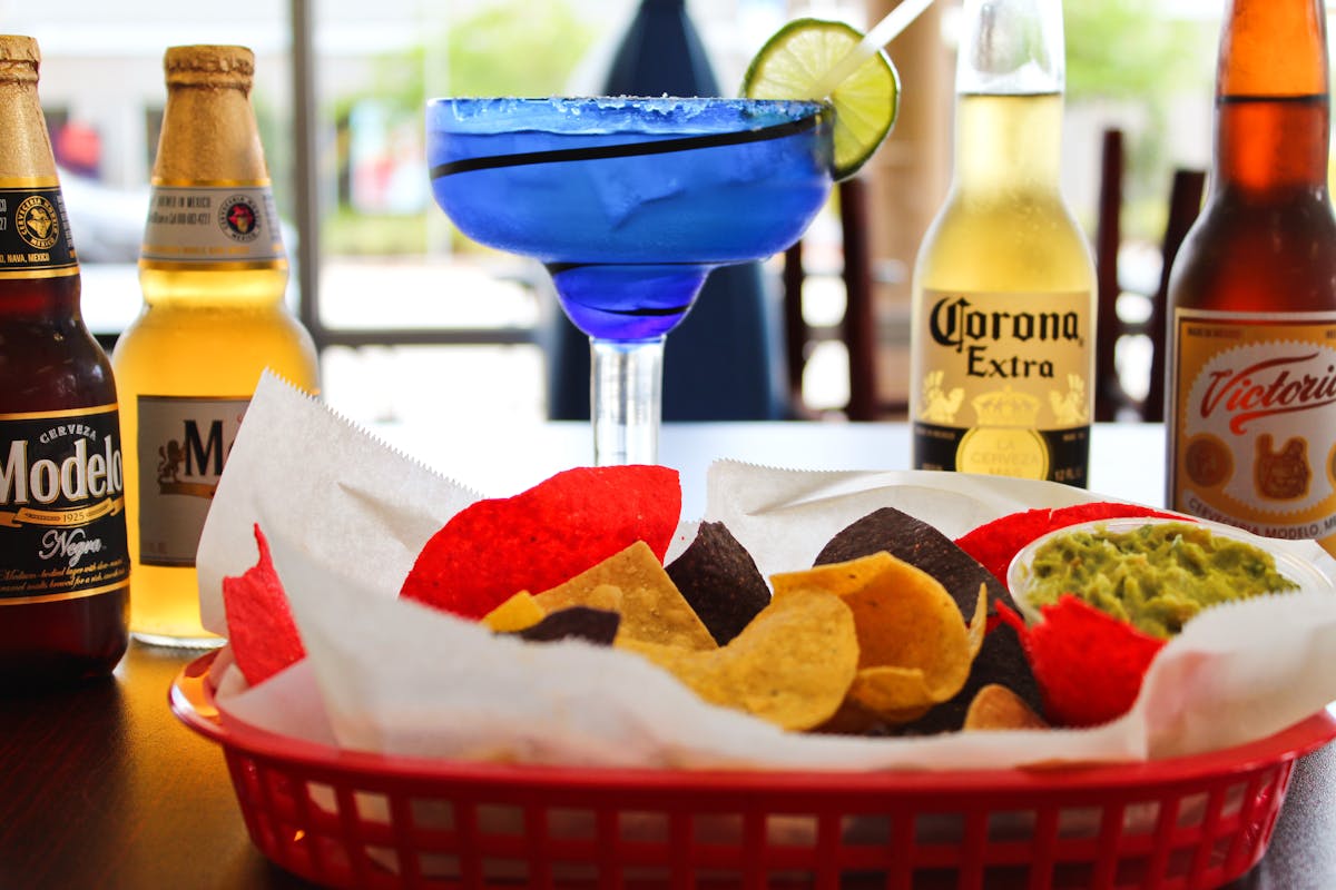 a table topped with plates of food and a bottle