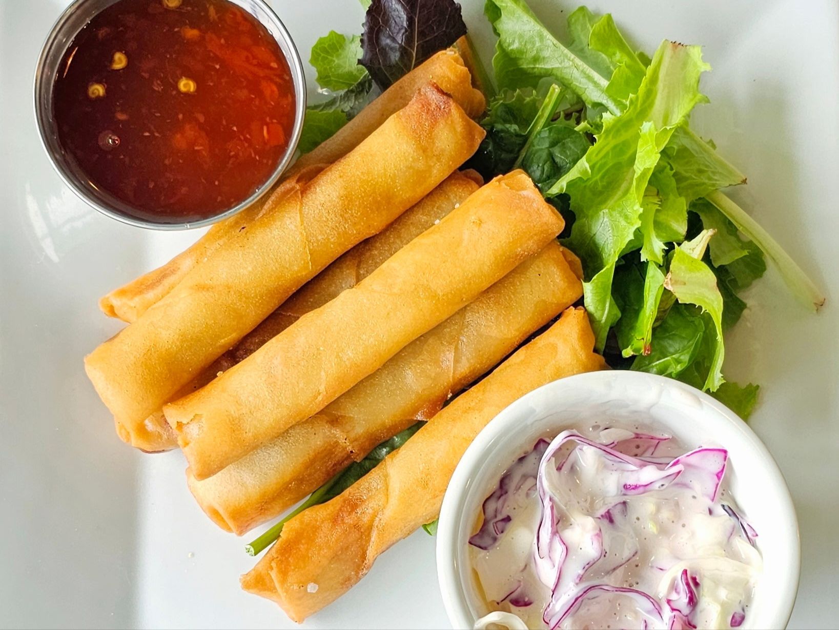 a plate of food with a sandwich and a salad