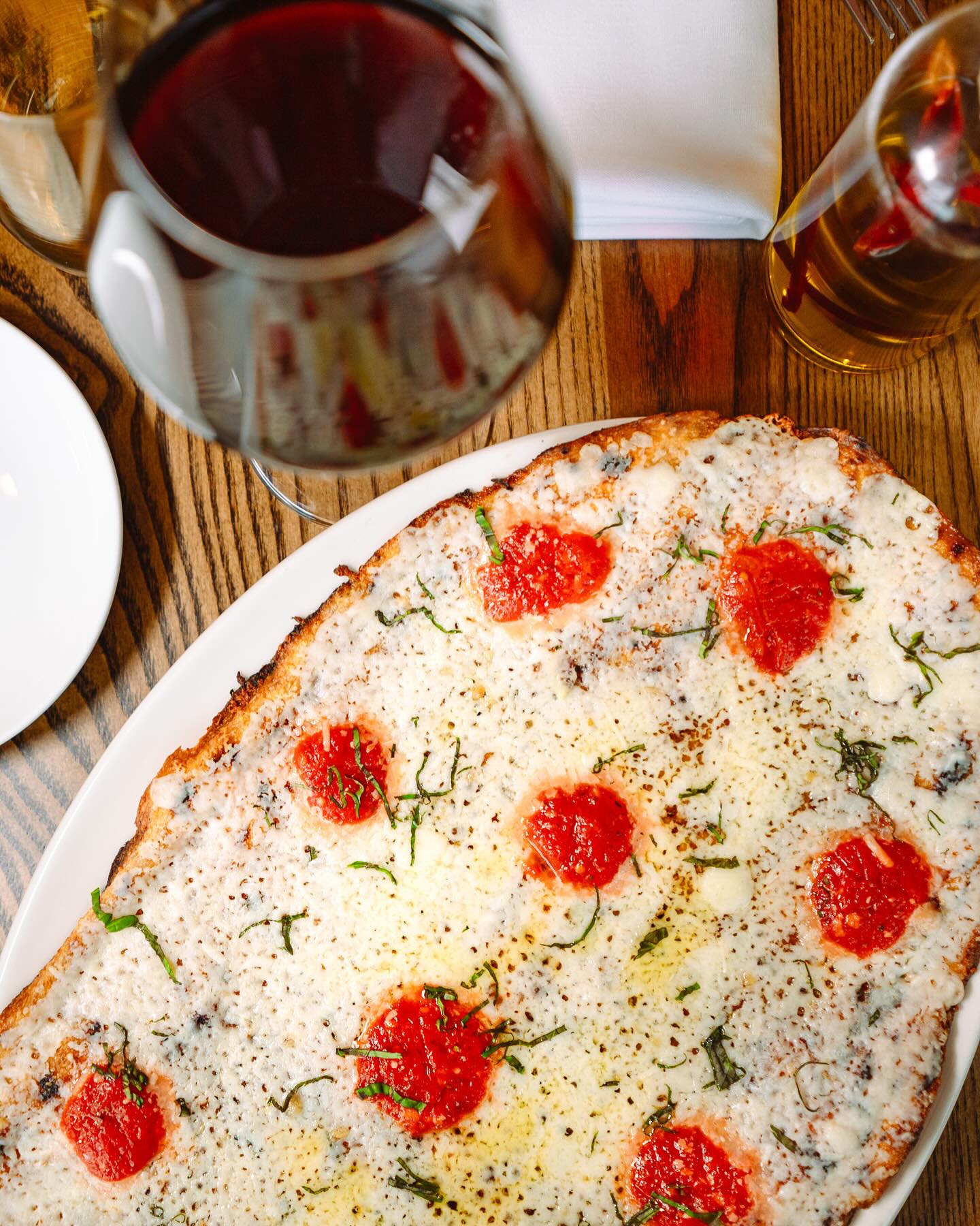 a plate of food with a slice of pizza on a table