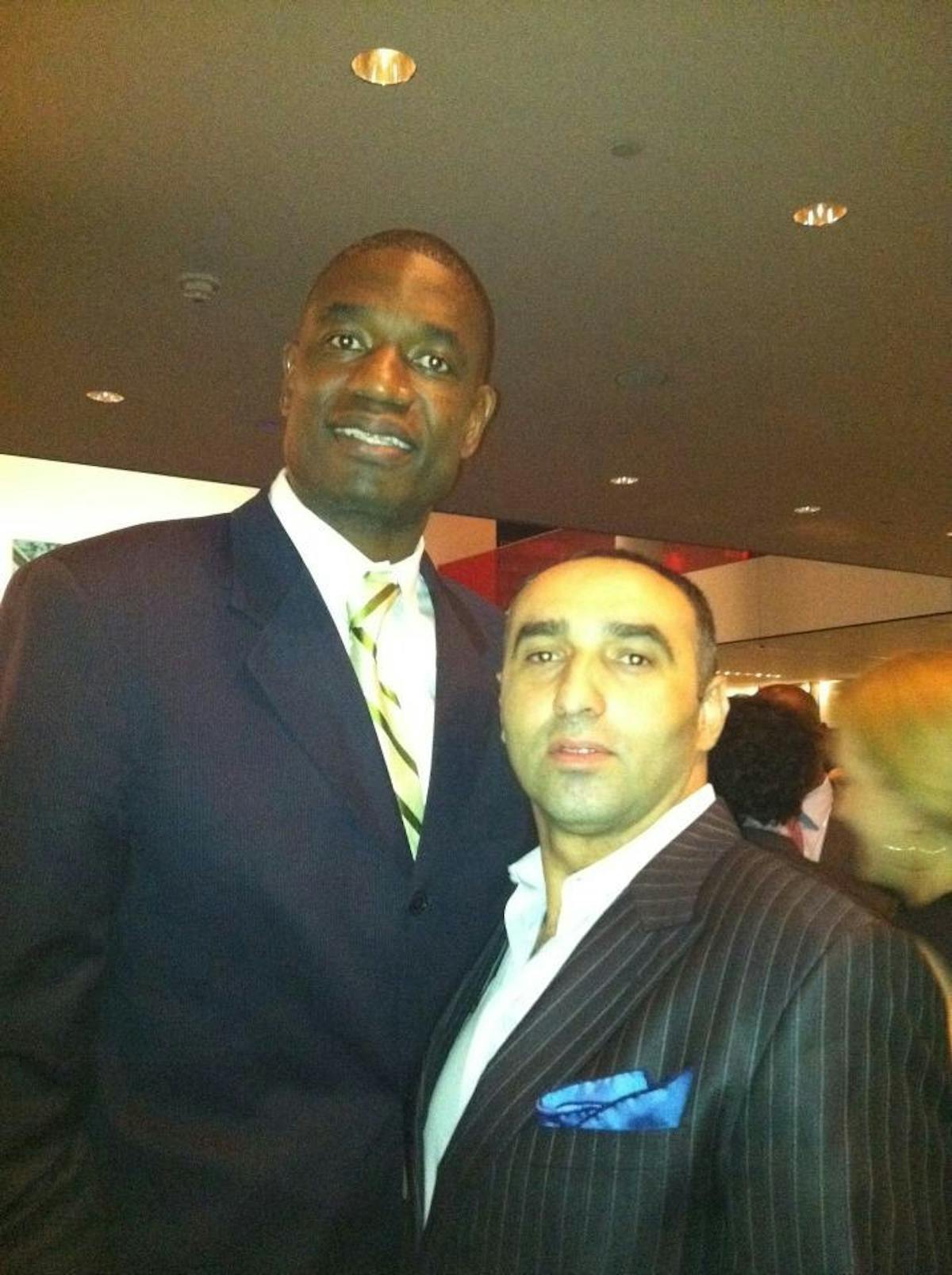 Dikembe Mutombo wearing a suit and tie