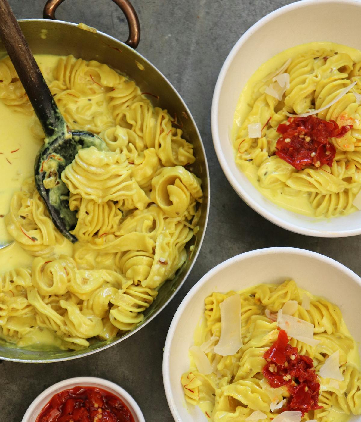 a bowl of pasta sits on a plate