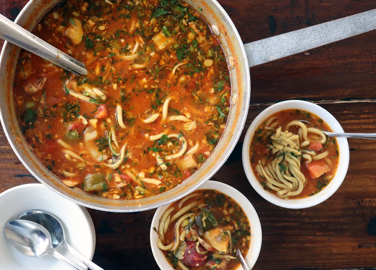 a bowl of food sitting on top of a wooden table