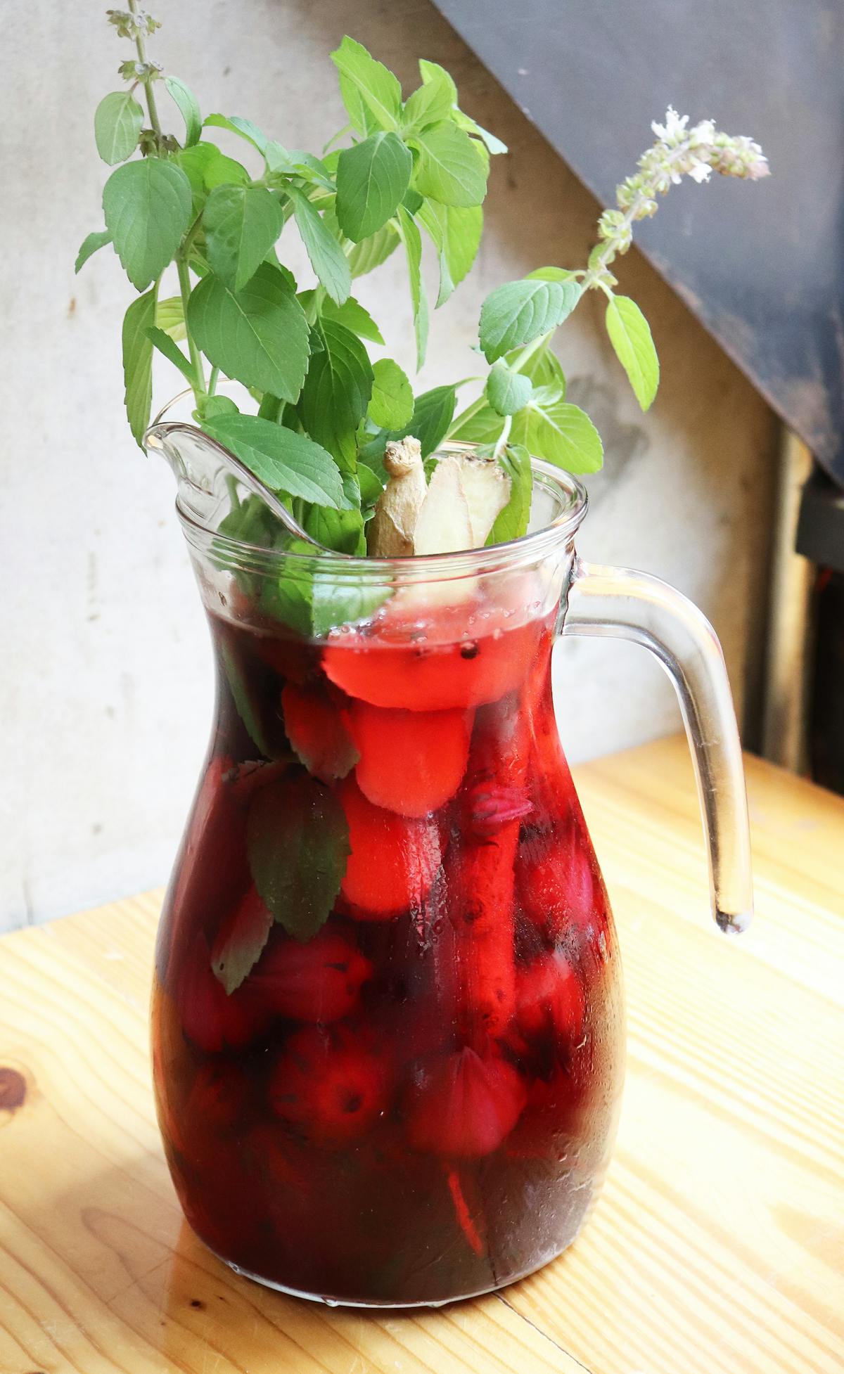 a vase filled with flowers sitting on top of a wooden table