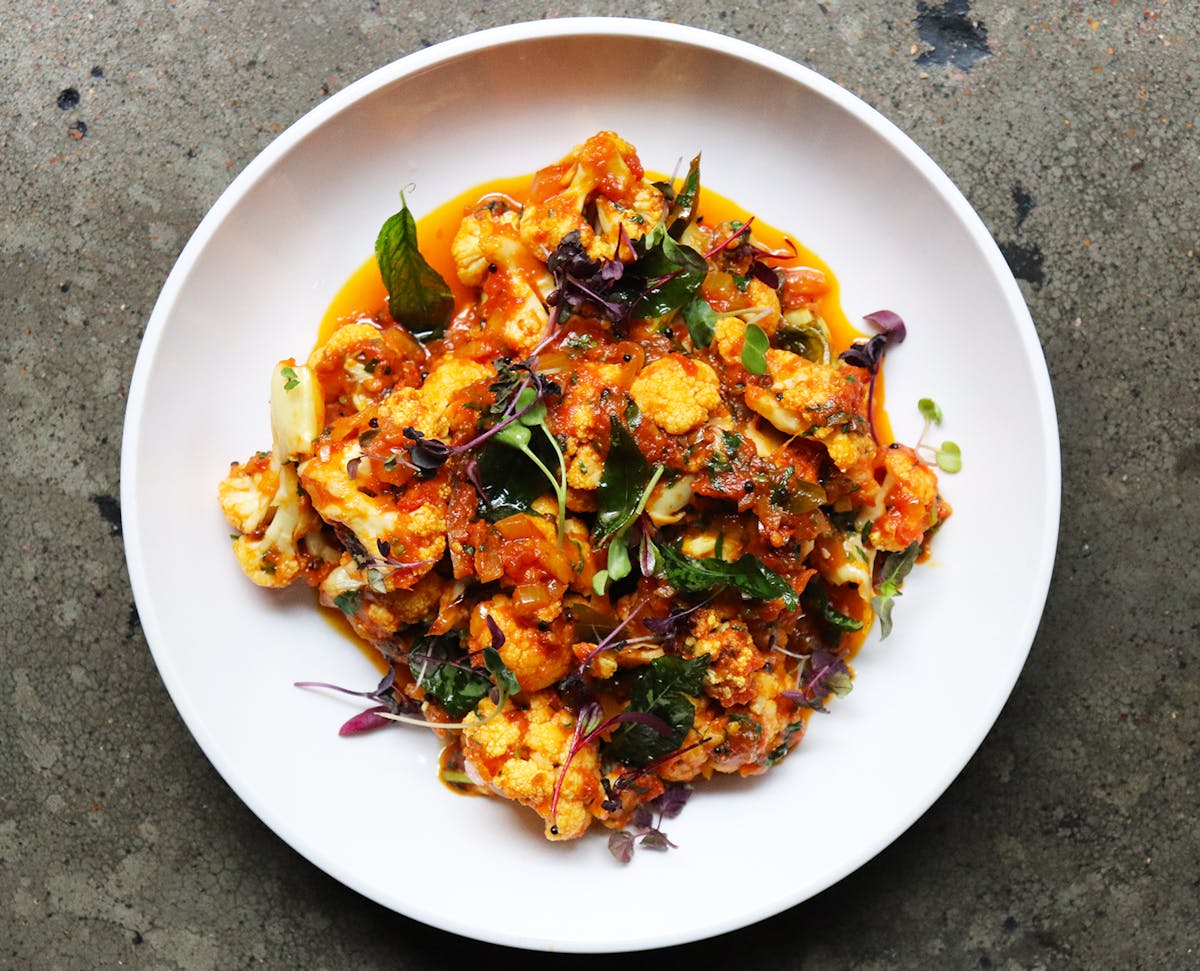 a plate of food with a slice of pizza