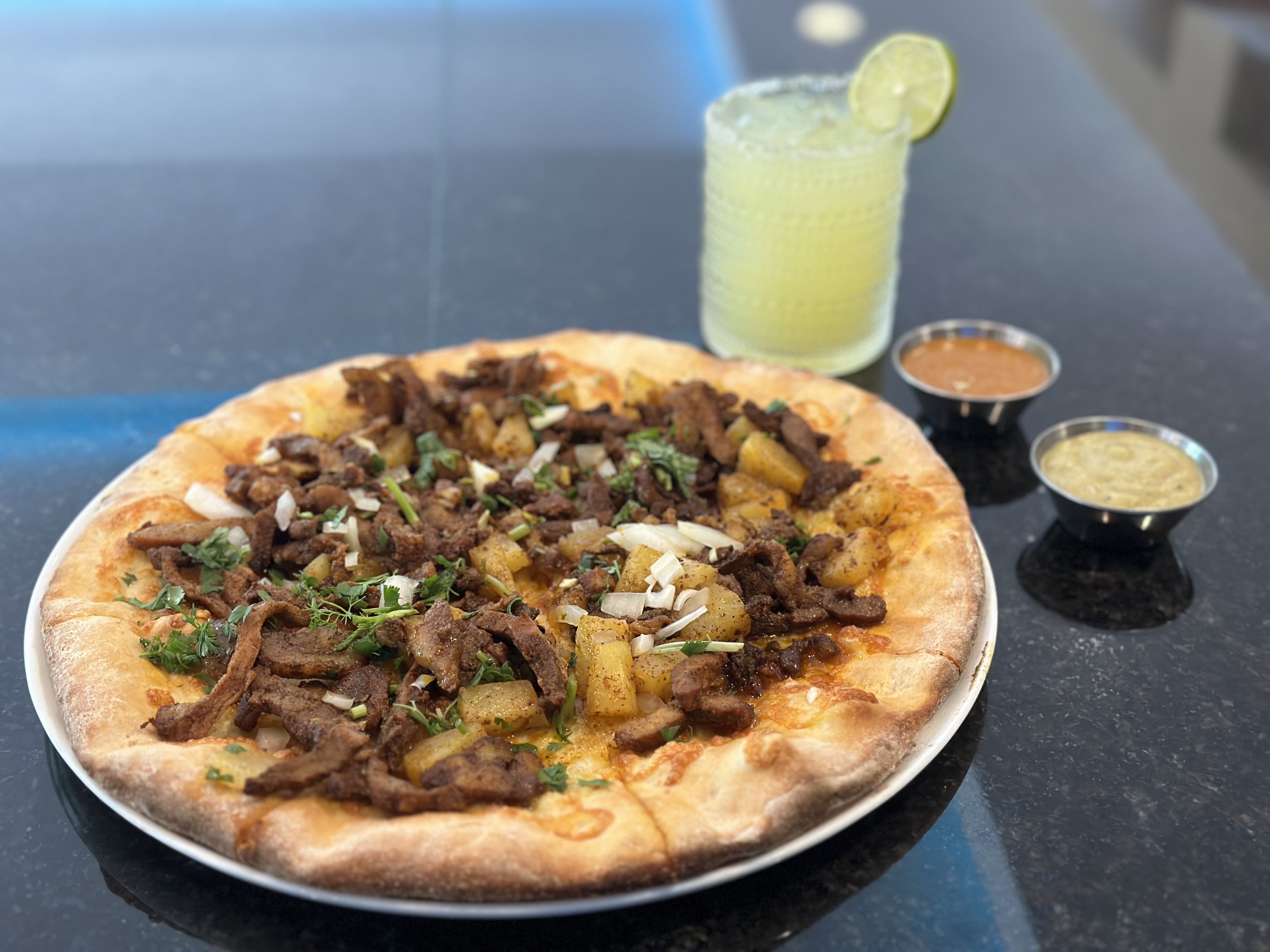 a pizza sitting on top of a plate of food