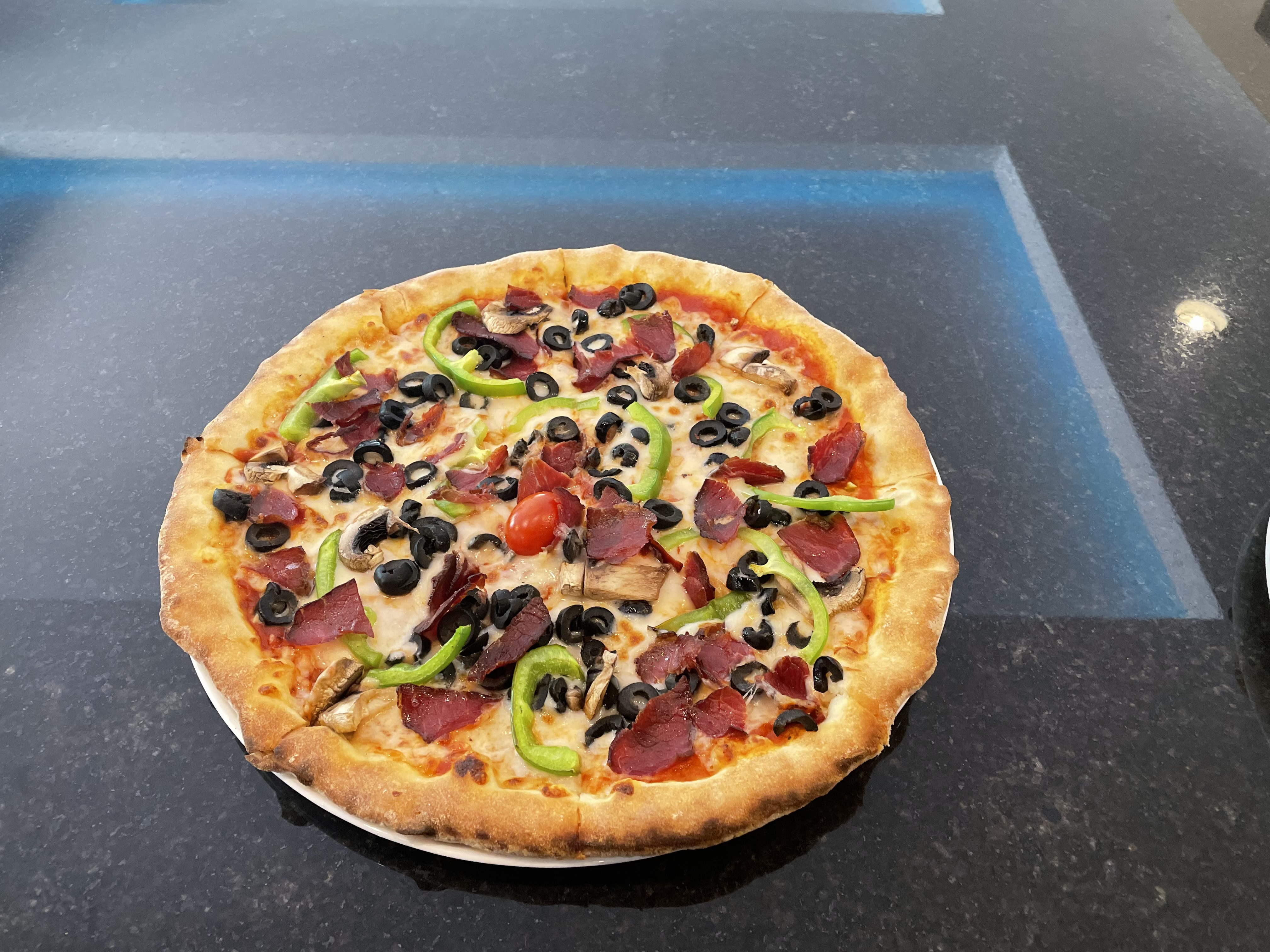 a pizza sitting on top of a counter