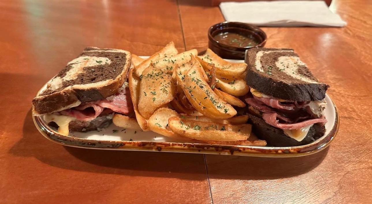 a sandwich sitting on top of a wooden table
