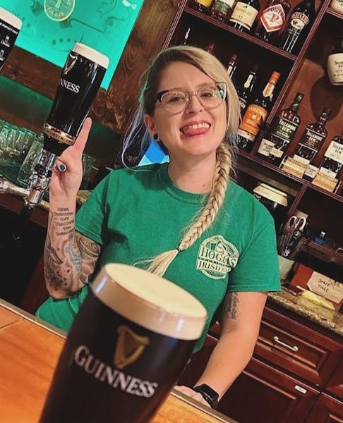 a person holding a cup of beer