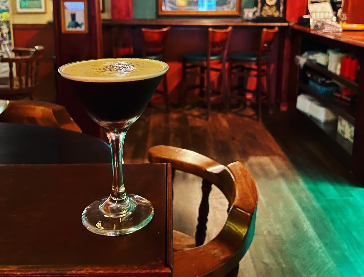 a glass of wine sitting on top of a table