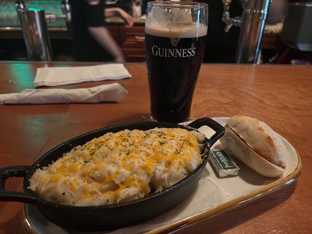 a plate of food with a glass of beer on a table