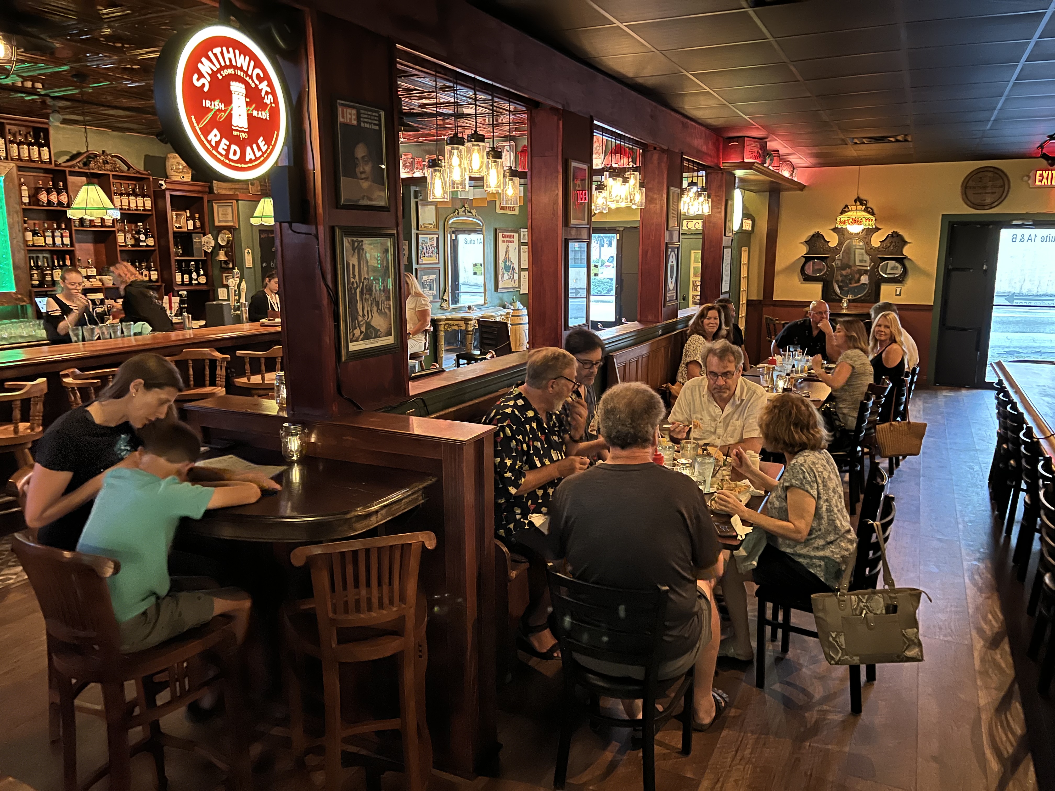 a group of people sitting at a table in a restaurant