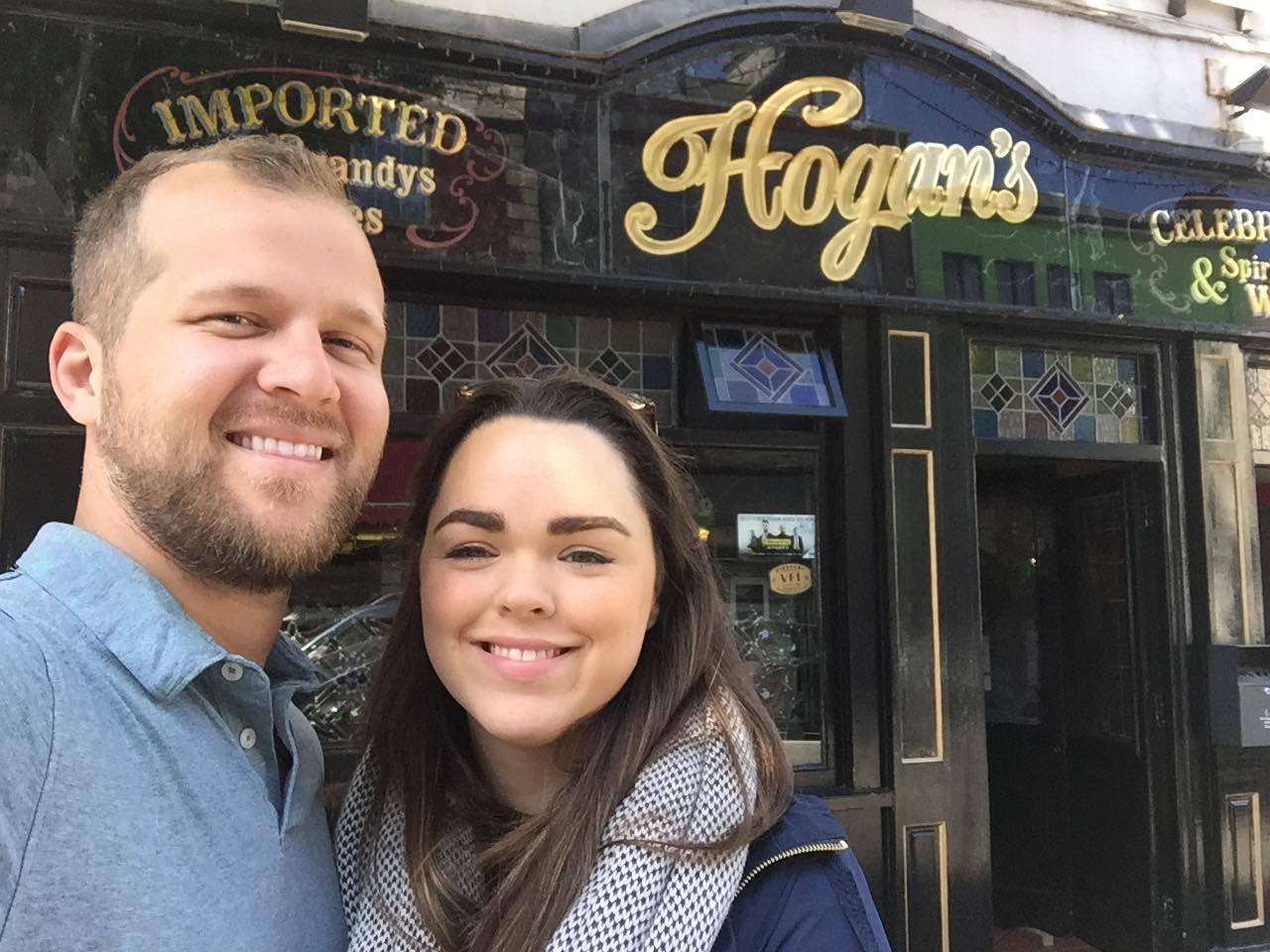 a man and a woman posing in front of a store