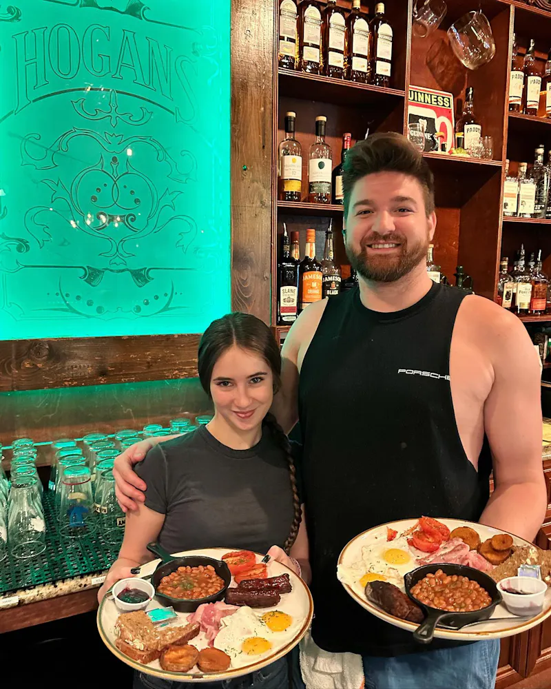 a woman standing in front of a plate of food