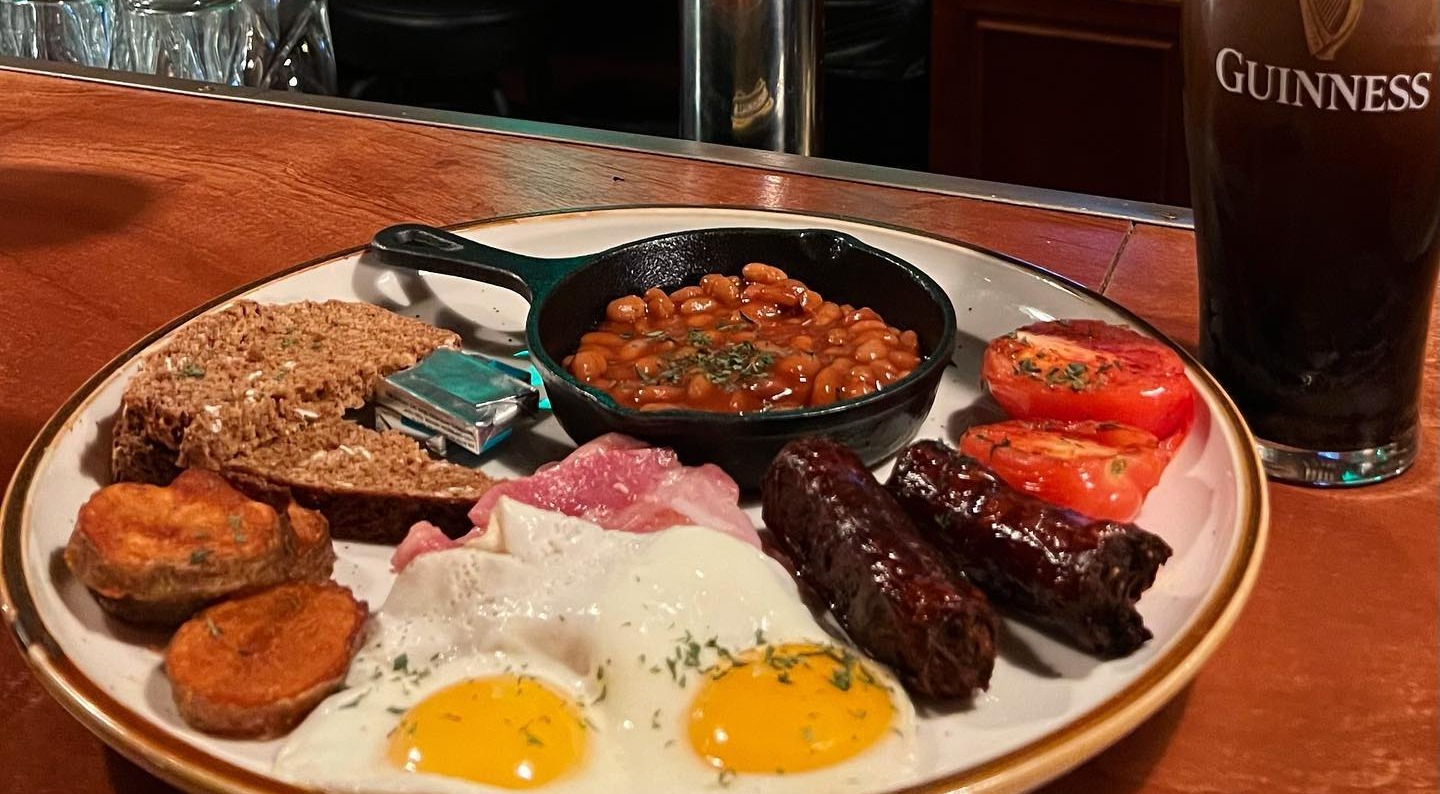 a plate of food with meat and vegetables in a cup